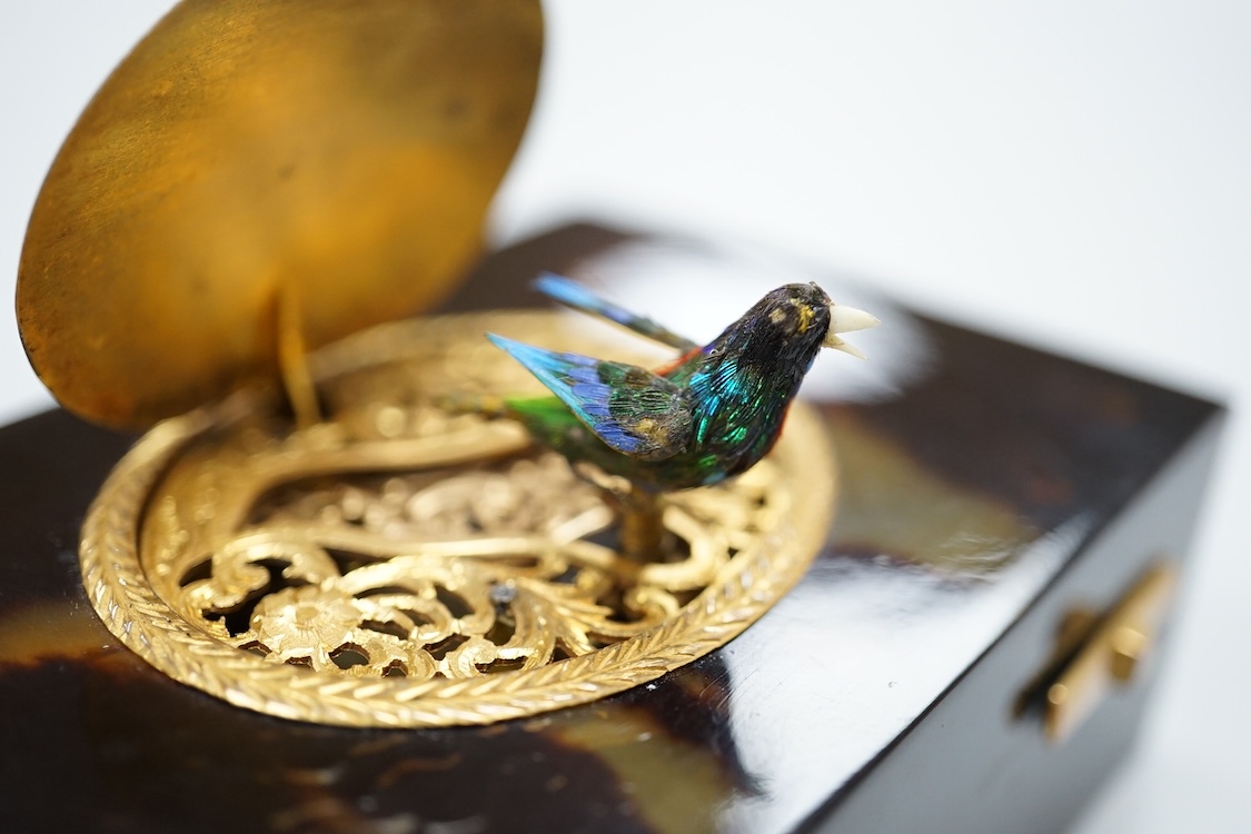 A Victorian white and yellow mounted singing automaton bird music box, damaged, with case and key